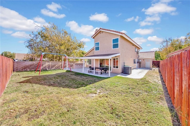 back of house with a patio area, a storage unit, a lawn, and central AC