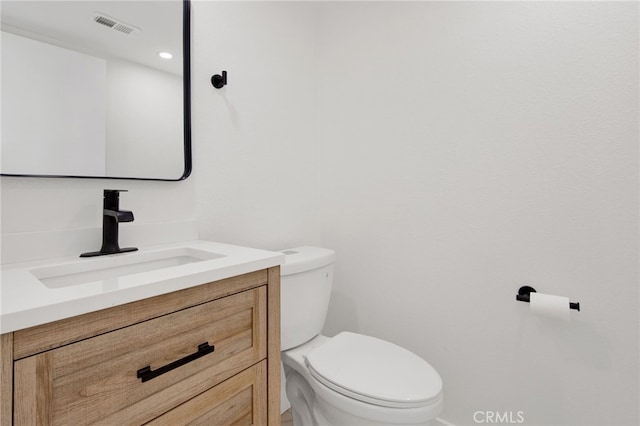 bathroom with toilet and vanity