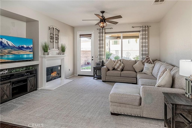 carpeted living room featuring ceiling fan