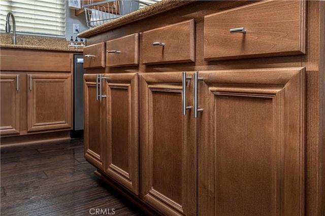 exterior details featuring stone countertops and sink