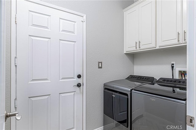 laundry area with cabinets and washer and dryer