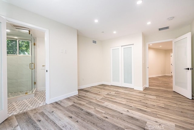 interior space with french doors and light wood-type flooring