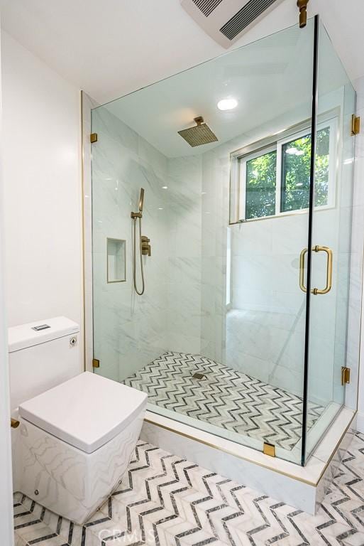 bathroom with a shower with door