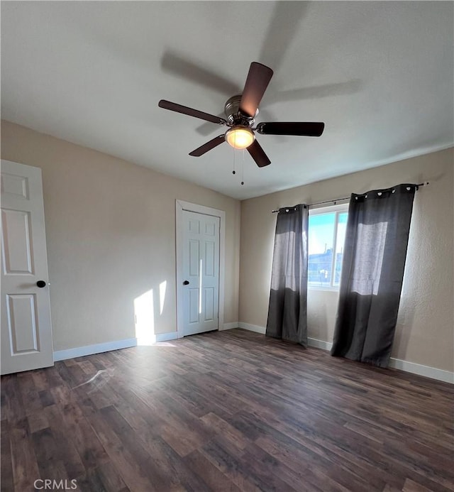 unfurnished bedroom featuring dark hardwood / wood-style floors, ceiling fan, and a closet