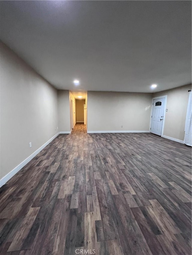 basement with dark hardwood / wood-style flooring