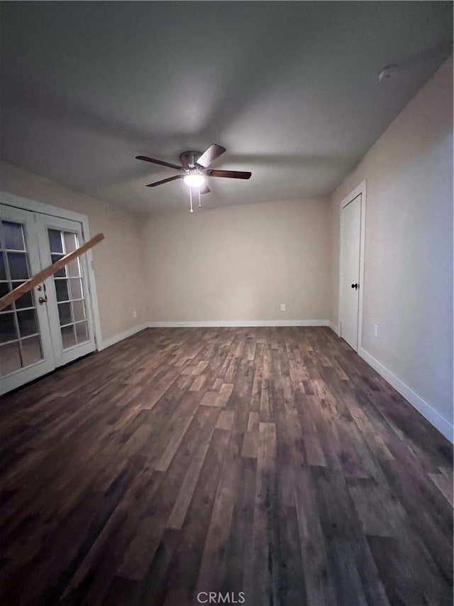 spare room featuring dark wood-type flooring, french doors, and ceiling fan