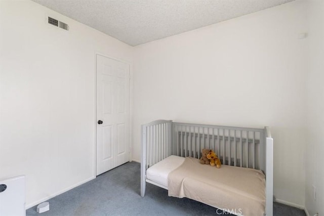 carpeted bedroom featuring a textured ceiling