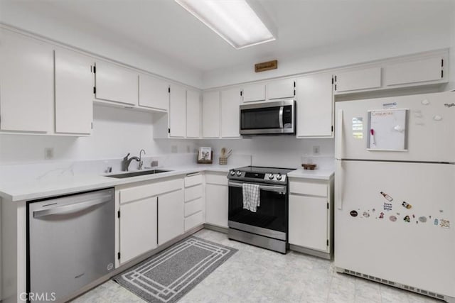 kitchen featuring sink, white cabinets, and appliances with stainless steel finishes