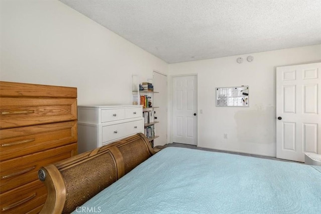 carpeted bedroom featuring a textured ceiling