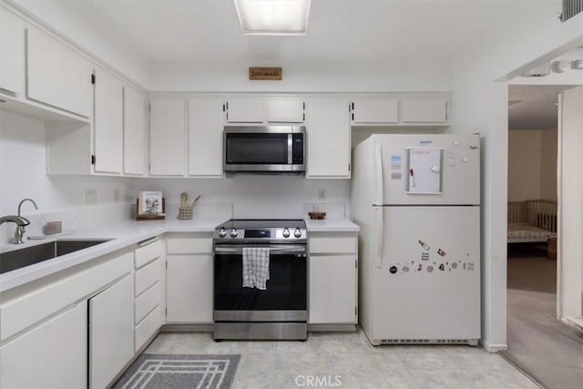 kitchen featuring white cabinetry, sink, and appliances with stainless steel finishes