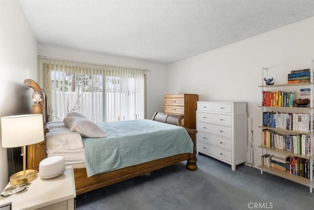 carpeted bedroom with a textured ceiling