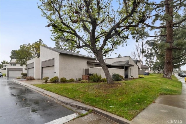 view of property exterior featuring a garage and a lawn