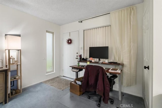 home office with carpet floors and a textured ceiling