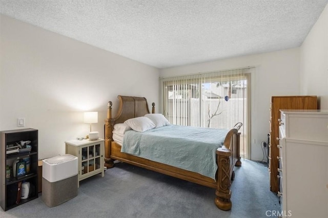 carpeted bedroom with access to exterior and a textured ceiling