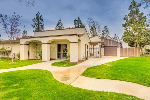 rear view of property with a garage and a yard