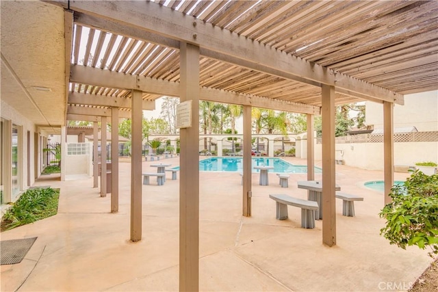 view of patio featuring a fenced in pool and a pergola