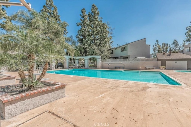 view of swimming pool featuring a patio area