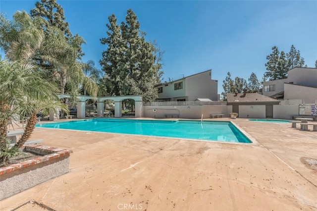 view of swimming pool with a patio