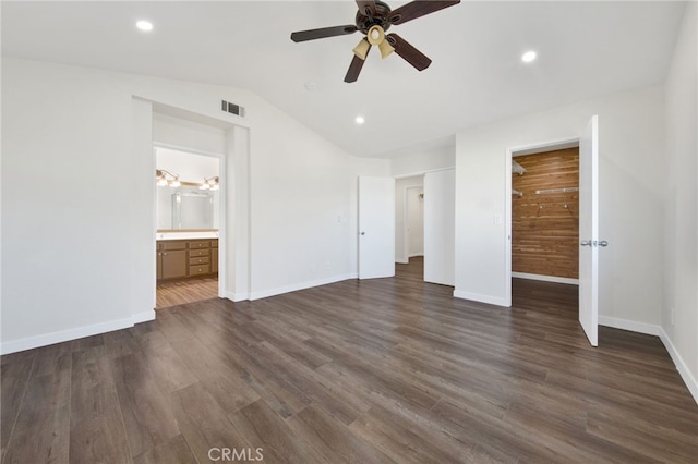 unfurnished bedroom with ensuite bath, ceiling fan, dark hardwood / wood-style floors, and lofted ceiling