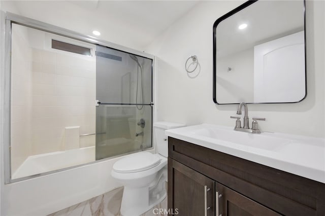 full bathroom with toilet, bath / shower combo with glass door, and vanity