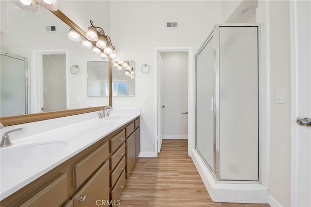 bathroom with vanity, hardwood / wood-style floors, and an enclosed shower