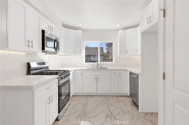 kitchen featuring sink, white cabinets, and stainless steel appliances