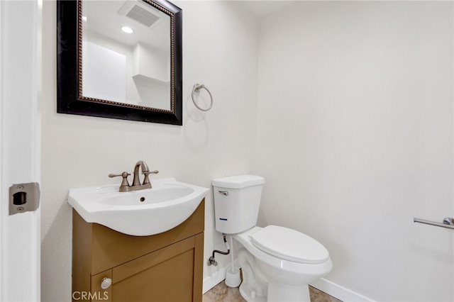 bathroom with toilet and vanity