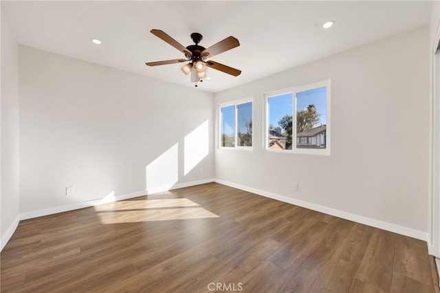 unfurnished room featuring ceiling fan and dark hardwood / wood-style flooring