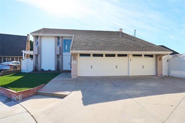 view of front of home featuring a garage and a front lawn