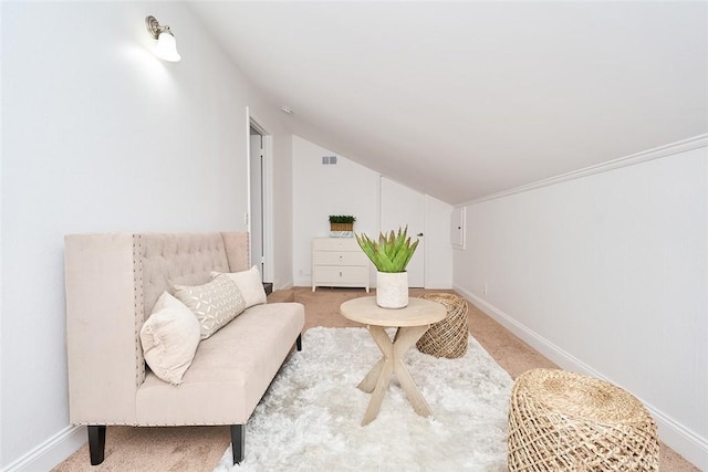 living area featuring light colored carpet and lofted ceiling