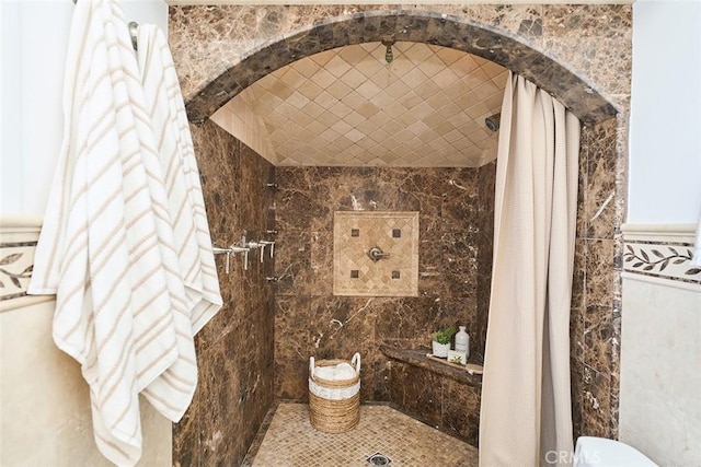 bathroom featuring tile walls and a shower with curtain