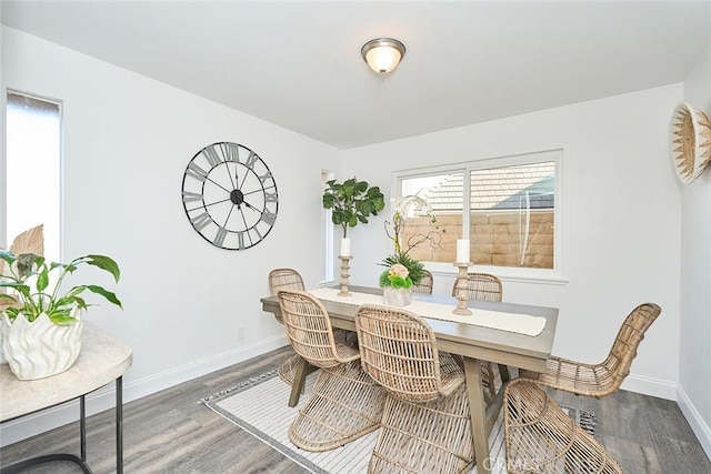 dining space with dark hardwood / wood-style flooring