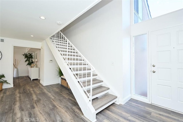 stairs featuring wood-type flooring