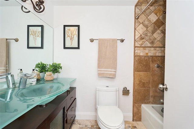 full bathroom with vanity, toilet, and tiled shower / bath combo