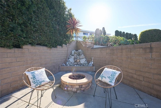 view of patio / terrace with an outdoor fire pit