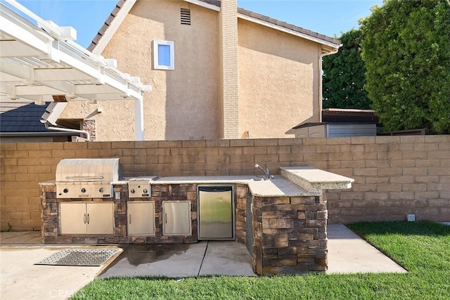 view of patio with area for grilling and exterior kitchen