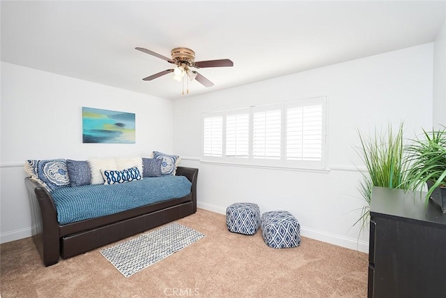 sitting room with ceiling fan and light carpet