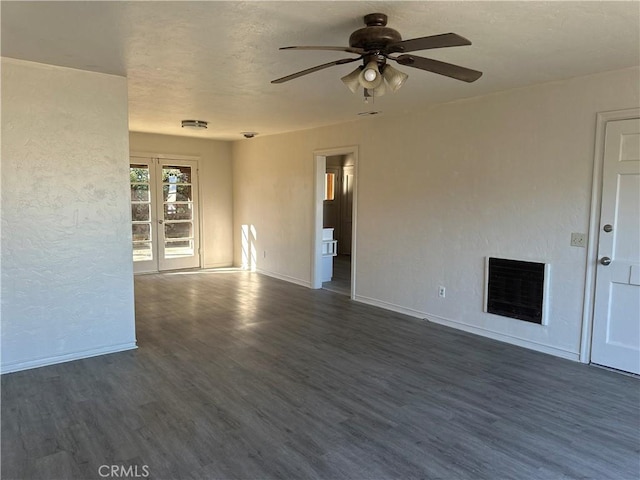 unfurnished living room with heating unit, french doors, dark wood-type flooring, and ceiling fan