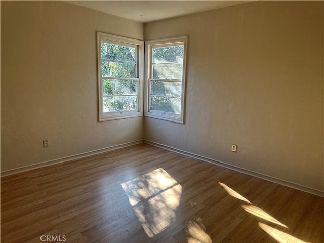 empty room with hardwood / wood-style floors