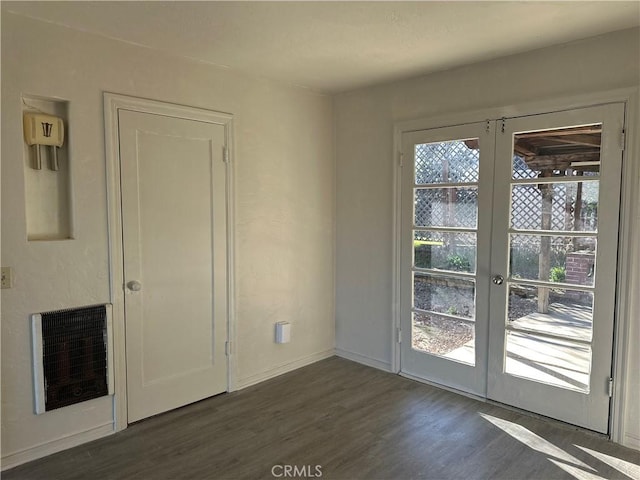 interior space featuring heating unit, french doors, and dark hardwood / wood-style flooring