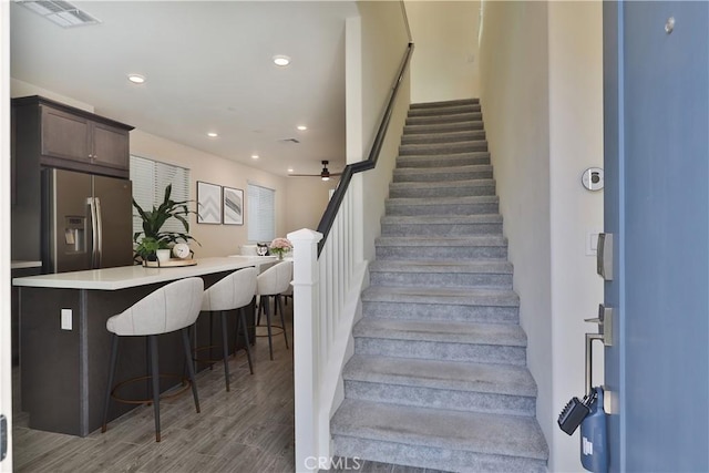 stairs featuring hardwood / wood-style floors