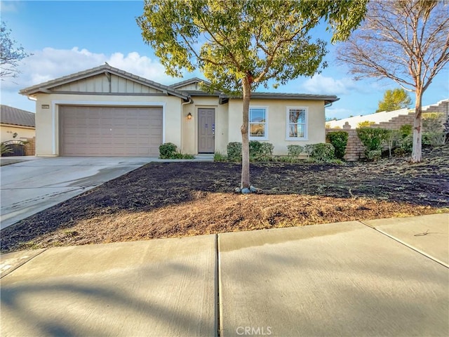 ranch-style home featuring a garage, board and batten siding, fence, and concrete driveway