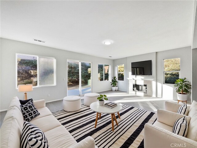 living room with a wealth of natural light and carpet floors