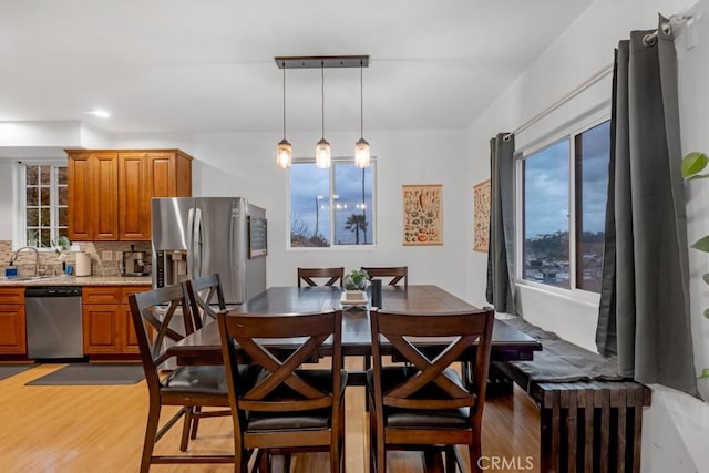 dining room with hardwood / wood-style flooring and sink