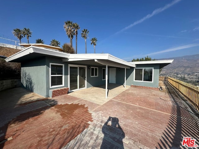 back of house with a patio area and a mountain view