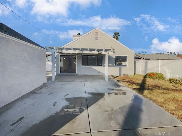 back of property with a patio area and a pergola