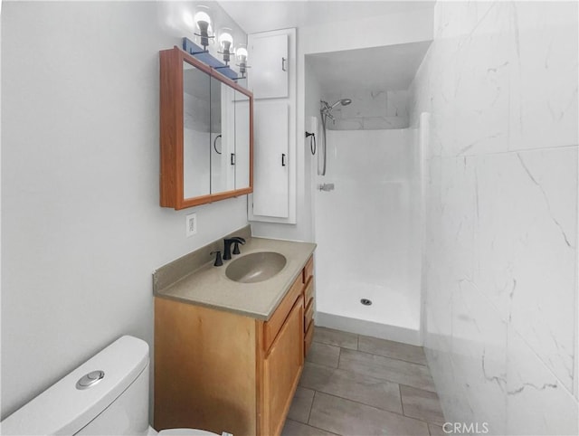 bathroom with walk in shower, vanity, and toilet