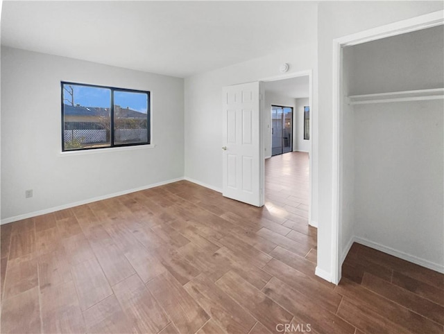 unfurnished bedroom featuring hardwood / wood-style flooring and a closet