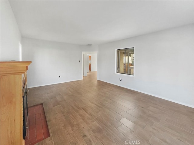 unfurnished living room with hardwood / wood-style flooring