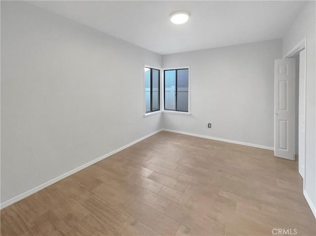 spare room featuring light wood-type flooring